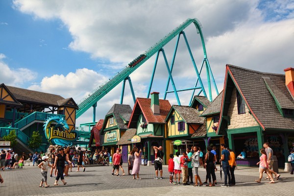 Vaughan, Ontario, Canada - July 26, 2014: People enjoying the summer time outdoors by spending time at Canada's Wonderland amusement park and riding the tallest and fastest roller coaster in Canada - the Leviathan. Taken in July 2014.